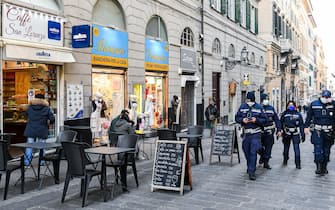 Local policemen walk by the entrance of a bar in the centre of town as Regione Liguria shifts to ÒYellow ZoneÓ following government decisions in order to contain the Coronavirus pandemic, in Genoa, Italy, 29 November 2020
ANSA/SIMONE ARVEDA