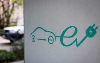A signage for electric vehicle charging station is pictured at a parking area in Bangkok on March 30, 2021. (Photo by Jack TAYLOR / AFP) (Photo by JACK TAYLOR/AFP via Getty Images)