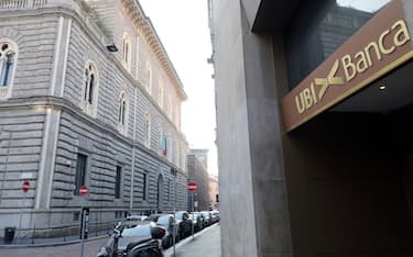A banner of a Ubi bank branch on background  The Ca' de Sass palace ("house of the stones", in reference to the rustication that adorns the facades) &nbsp;headquarters of Intesa Sanpaolo in Milan, Italy, 18 February 2020.&nbsp;&nbsp;Intesa Sanpaolo offers 17 treasury shares for 10 Ubi shares, valuing it at 4.9 billion euros. ANSA/MATTEO BAZZI