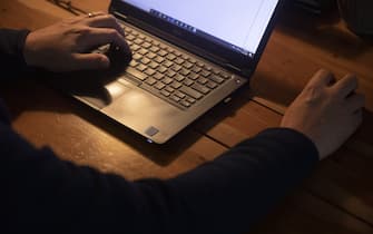 A person works from home on a laptop computer in Princeton, Illinois, U.S., on Friday, Sept. 11, 2020. Illinois reported 1,337 new coronavirus cases Wednesday as the state's positivity rate dropped below 4% for the first time in weeks. Photographer: Daniel Acker/Bloomberg