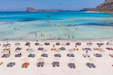 Aerial view from a drone of Balos Beach, the incredible lagoon with the turquoise exotic and tropical water of the Mediterranean sea  is located in Chania region in Crete Island. Balos is one of the most visited beaches in Crete and popular for visitors around the world. Crystal clear water, the lagoon, rocky steep mountains, a beach bar providing umbrellas and shadow with beverages and a pirate island are located at the same region that is accessible by a 20 min trek or boat. Greece is trying to boost its tourism and give privileges to vaccinated against Covid-19 Coronavirus pandemic international tourists and locals, as the country is heavily depended from the tourism industry. Balos, Chania, Greece on June 13, 2021 (Photo by Nicolas Economou/NurPhoto via Getty Images)