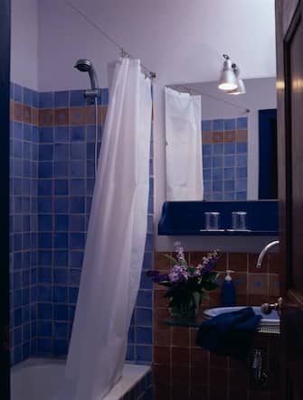 Partial view of a blue tiled bathroom. (Photo by Quick Image/Construction Photography/Avalon/Getty Images)