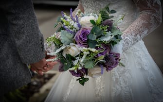 BLACKWOOD, WALES, - 30 NOVEMBER:  A general view of a bride and groom holding hand after their wedding service on November 30, 2019 in Blackwood, Wales, United Kingdom. The Welsh Government has announce a further relaxation of restrictions, post wedding celebration meals can now be increased to a maximum of 30 guests(Photo by Huw Fairclough/Getty Images)