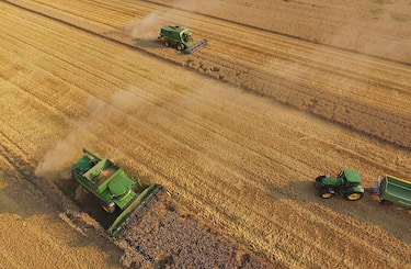 GROSSDERSCHAU, GERMANY - AUGUST 14:  In this aerial view combines harvest summer wheat at a cooperative farm on August 14, 2015 near Grossderschau, Germany. The German Farmers' Association (Deutscher Bauernverband) is due to announce annual grain harvest results this week. Some farmers have reported a disappointing harvest due to the dry weather in recent months.   (Photo by Sean Gallup/Getty Images)