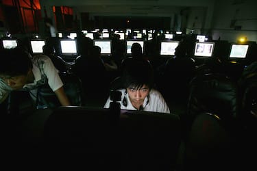 WUHAN, CHINA - JUNE 11:  Chinese youngsters play online games overnight at an internet cafe on June 11, 2005 in Wuhan, Hubei Province of China. There are near 2,000 internet cafes in Wuhan, and the largest one has more than 1,000 computers. Most of the customers are students from middle schools and colleges, and the cost for overnight playing of each person is 6 Yuan (US$0.7). China has strengthened its supervision and management of computer games as more and more youngsters have indulged themselves in Internet, according to the state media.  (Photo by Cancan Chu/Getty Images)