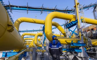 1235855494 A worker checks the pressure gauge on pipework at the Comprehensive Gas Treatment Unit No.3 of the Gazprom PJSC Chayandinskoye oil, gas and condensate field, a resource base for the Power of Siberia gas pipeline, in the Lensk district of the Sakha Republic, Russia, on Monday, Oct. 11, 2021. Amid record daily swings of as much as 40% in European gas prices, Russian President Vladimir Putin made a calculated intervention to cool the market last week by saying Gazprom can boost supplies to help ease shortages. Photographer: Andrey Rudakov/Bloomberg