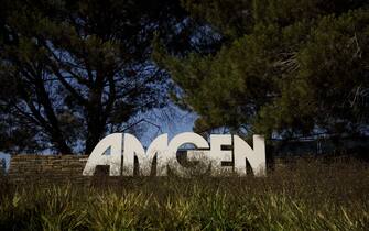Signage is displayed outside Amgen Inc. headquarters in Thousand Oaks, California, U.S., on Thursday, Aug. 27, 2020. Amgen is among the world's biggest biotechnology companies with a market value of about $137 billion, though it's replacing a company -- Pfizer Inc. -- that is about $90 billion larger. Photographer: Patrick T. Fallon/Bloomberg via Getty Images