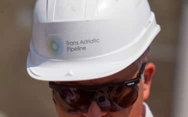 A worker wears a hardhat bearing the logo of Trans-Adriatic Pipeline at the pipeline receiving terminal construction site in Melendugno, Italy, on Tuesday, May 22, 2018. The Trans-Adriatic Pipeline, known as TAP,Â is a a 4.5 billion-euro ($5.2 billion) natural gas pipeline that will bringÂ gas from Azerbaijan, winding through Greece and Albania, under the Adriatic Sea and finally up into Italy, which imports more than 90 percent of its oil and gas. Photographer: Giulio Napolitano/Bloomberg via Getty Images
