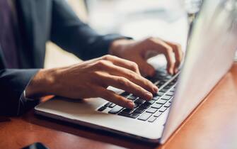 1028869800 Close up of a hands of a businessman on a keyboard.