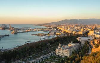 Spain, Malaga, view over the harbour and the townhall by sunrise