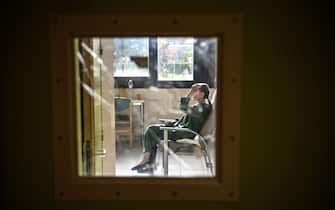 A patient with mental disorders sits on a chair in her room at The Ville-Evrard Psychiatric Hospital in Saint-Denis, north of Paris on November 3, 2020. - After the consequences of the first confinement linked to Covid-19 are just starting to fall as psychiatrists at the mental health establishment of Ville-Evrard, in the Paris suburbs, fear a second "psychiatric wave". (Photo by Christophe ARCHAMBAULT / AFP) (Photo by CHRISTOPHE ARCHAMBAULT/AFP via Getty Images)