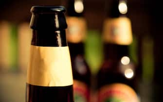 Outdoor picnic beer bottle out of focus background bokeh no logo