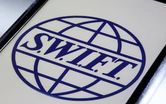 PARIS, FRANCE - FEBRUARY 26: In this photo illustration, the SWIFT logo is displayed on the screen of an iPhone on February 26, 2022 in Paris, France. Following Russia's invasion of Ukraine, discussions between Western countries are progressing on Russia's exclusion from the SWIFT interbank network, Lithuanian Prime Minister Ingrida Simonyte announced on Saturday. The decision to cut Russia from the SWIFT network is expected to come in the coming days, Canada, the United States, Britain and the European Union said on Friday they could take steps to exclude Russia from the international system. SWIFT of interbank payments as part of a new round of sanctions to punish Moscow for the invasion launched in Ukraine.The Society for Worldwide Interbank Financial Telecommunication, known by the acronym SWIFT, is an interbank network that offers an extremely diversified range of services: account-to-account transfers, currency or securities transactions, collections. (Photo illustration by Chesnot/Getty Images)