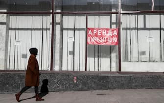 epa09793937 A Russian woman walks in front of a closed shop in Moscow, Russia, 01 March 2022. Russian troops entered Ukraine on 24 February prompting the country's president to declare martial law and triggering a series of severe economic sanctions imposed by Western countries on Russia. Starting from 28 February, the Central Bank of Russia decided to increase the key rate to 20 percent per annum, in an attempt to ensure financial and price stability.  EPA/YURI KOCHETKOV