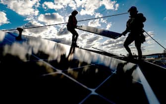 Bloomberg Best of the Year 2021: Solarpro employees install LG Electronics Inc. NeON R 370W solar panels onto the rooftop of a residential property in Sydney, Australia, on Monday, May 17, 2021. Photographer: Brendon Thorne/Bloomberg via Getty Images