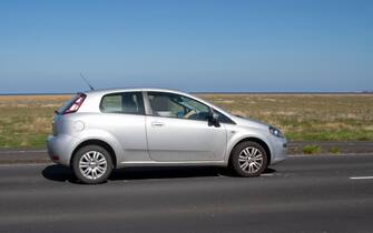2013 silver Fiat Punto Easy; Vehicular traffic moving vehicles, driving vehicle on UK roads, motors, motoring in Southport, UK
