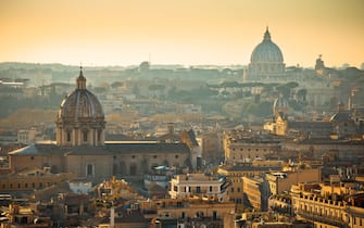Eternal city of Rome rooftops and towers golden sunset view, capital of Italy