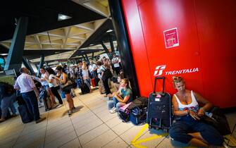 Passengers waiting at Central train station in Naples, southern Italy, 22 July 2019. An arson fire in a rail transformer room on the outskirts of Florence caused train chaos in Italy on Monday. The fire at the high-speed transformer caused long delays in both directions on the main north-south line. Network company RFI said the fire was started "by a deliberate act by person or persons unknown". RFI said some 25 high-speed trains had been cancelled, run by both Trenitalia and Italo. ANSA/ CESARE ABBATE