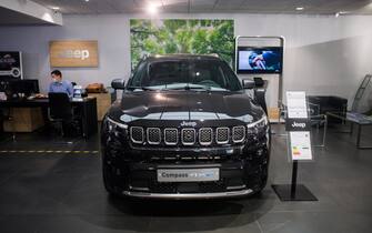 1234403384 A Jeep Compass 4xE hybrid sports utility vehicle (SUV) in a Jeep showroom, operated by Stellantis NV, in Paris, France, on Monday, Aug. 2, 2021. Stellantis reports first half earnings on Aug. 3. Photographer: Nathan Laine/Bloomberg