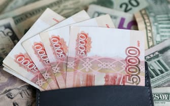 Russian Banknotes Against Blurred US Paper Currency Background