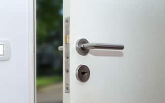 Open door of a family home. Close-up of lock an armored entrance door of the front of house.  Security. Interior view.