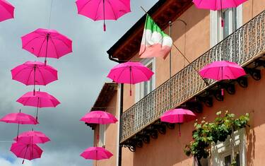 GUARDIA SANFRAMONDI, BENEVENTO, ITALY - 2021/05/15: Pink umbrellas and the Italian flag used as set-up, during stage 8 of the Giro d'italia 104, Foggia - Guardia Sanframondi of 170km. (Photo by Vincenzo Izzo/LightRocket via Getty Images)