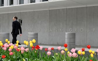 A man walks past the World Bank building in Washington, DC on April 21, 2022. - The 2022 Spring Meetings of the World Bank Group and the International Monetary Fund take place 18-24 April 2022. (Photo by Eva HAMBACH / AFP) (Photo by EVA HAMBACH/AFP via Getty Images)