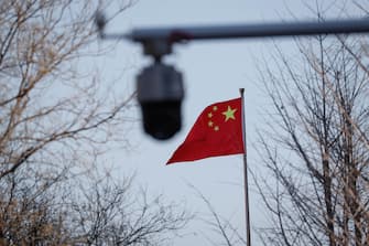 epa09861306 A camera on a street is seen besides a Chinese national flag outside the Beijing No. 2 Intermediate People's Court in Beijing, China, 31 March 2022. Australian journalist Chen Lei who faces accusations of supplying state secrets overseas faced a Chinese court after being detained for 19 months.  EPA/MARK R. CRISTINO