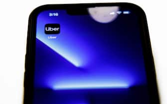 In this photo illustration, the Uber app is seen on an iPhone 13 Pro in Washington, DC, on July 10, 2022. - A leaked cache of confidential files from ride-sharing app Uber illustrates ethically dubious and potentially illegal tactics the company used to fuel its frenetic global expansion beginning nearly a decade ago, a joint media investigation showed Sunday. (Photo by Samuel Corum / AFP) (Photo by SAMUEL CORUM/AFP via Getty Images)