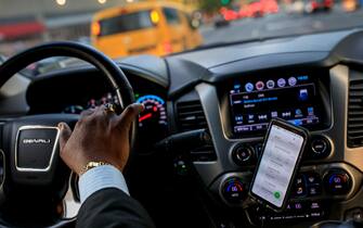 NEW YORK, NY - AUGUST 8: After dropping off passengers at a Broadway play, Johan Nijman, a for-hire driver who runs his own service and also drives for Uber on the side, drives through the West Side of Manhattan on Wednesday evening, August 8, 2018 in New York City. On Wednesday, New York City became the first American city to halt new vehicles for ride-hail services. The legislation passed by the New York City Council will cap the number of for-hire vehicles for one year while the city studies the industry. The move marks a setback for Uber in its largest U.S. market. Nijman, a member of the Independent Drivers Guild who has been driving in various capacities since 1991, says the temporary vehicle cap is a good start but he would like to see the city do more to deal with the over-saturation of vehicles and new drivers. (Photo by Drew Angerer/Getty Images)