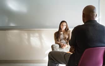 Student and psychologist talking in classroom