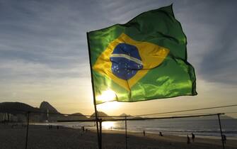 A flag flies on Copacabana Beach at sunrise in Rio de Janeiro, Brazil, June 8, 2014.  