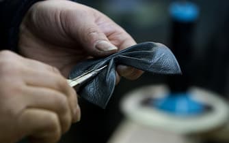 A shoemaker uses tweezers to shape a piece of leather at a Beauty-M. Phil-Lip handmade shoe factory in the area of Seongsu-dong in Seoul, South Korea, on Friday, Jan. 30, 2015. Consumer prices rose 0.8 percent in January from a year earlier, matching December's increase and less than the 0.9 percent median estimate in a Bloomberg survey of economists. Photographer: SeongJoon Cho/Bloomberg via Getty Images