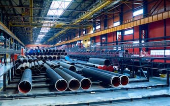 Abundance of tubes used for oil and gas industry placed in factory warehouse