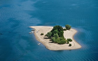 Netherlands, Tolkamer near Lobith, People relaxing on little island in lake called De Bijland. Aerial