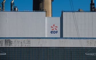 A logo on the exterior of the decomissioned Porcheville fuel power plant, operated by Electricite de France SA (EDF), in Porcheville, France, on Friday, July 8, 2022. The French government will nationalize its financially struggling nuclear giant Electricite de France SA to help it ride out Europe’s worst energy crisis in a generation and invest in new atomic plants. Photographer: Nathan Laine/Bloomberg