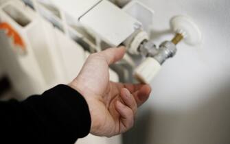 Turn the crank of a home radiator for maintenance