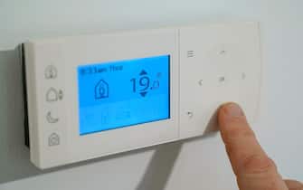 A homeowner turns down the temperature of a central heating thermostat in Basingstoke, Hampshire. Ofgem is expected to announce that the energy price cap is to rise by 50 percent because of soaring wholesale gas prices, meaning the average bill could hit £1,915. Picture date: Thursday February 3, 2022. (Photo by Andrew Matthews/PA Images via Getty Images)