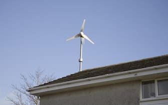 Micro wind generator on roof of house a good mwthod of reducing household bills. (Photo by Universal Images Group via Getty Images)