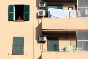 A resident peers from a window of an apartment in Rome, Italy, on Friday, Nov. 27, 2020. Italy on Monday became the second European nation after the U.K. to reach 50,000 deaths from the coronavirus pandemic. Photographer: Alessia Pierdomenico/Bloomberg via Getty Images