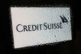 Credit Suisse logo displayed on a phone screen is seen through waterdrops on a window in this illustration photo taken in Krakow, Poland on June 9, 2022. (Photo by Jakub Porzycki/NurPhoto via Getty Images)