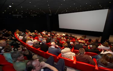 people watching a cinema screen in a theatre