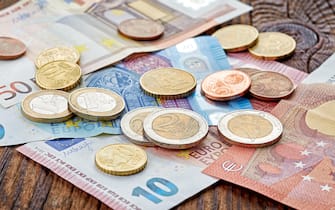 Money Euro banknotes and coins on wooden table