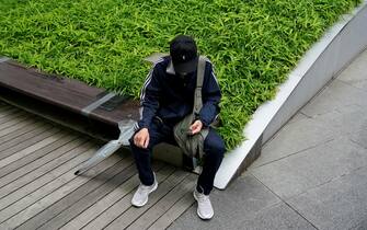 JAPAN UNEMPLOYMENT RATE epa09987419 A man sits looking at his smartphone in Tokyo, Japan, 31 May 2022. According to Japan's Ministry of Internal Affairs and Communications, the April 2022 seasonally-adjusted unemployment rate was 2.5 percent, down 0.1 points from the previous month, showing improvement after all coronavirus spread prevention measures were lifted nationwide in late March. EPA/FRANCK ROBICHON