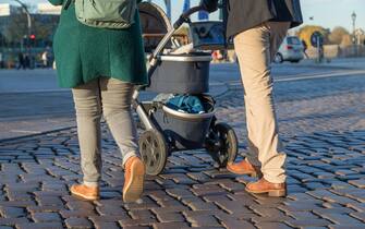 couple ist walking with stroller