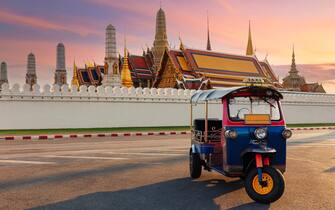 Tuk Tuk Taxi or Three-Wheel Vehicle with Wat Phra Kaeo background, Travel or Holiday Concept.