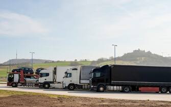Group of supplies Tir camion on motorway parking,shipment goods transportation