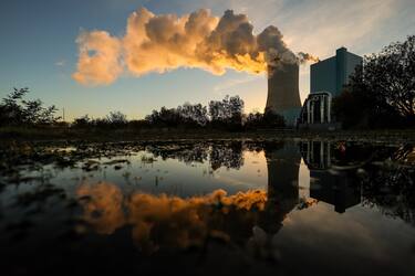 epa09562861 The steaming coal-fired power plant Datteln 4 is reflected in the water of the Dortmund-Ems-Canal in Datteln, Germany, 02 November 2021 (issued 04 November 2021). The production of carbon-based energy is one of the main sources of environmental pollution worldwide and the black coal consuming plant was controversial already before launched in May 2020. Germany, a coal extracting country, is striving to abolish coal and nuclear power and to convert to renewable energies, one of the main topics of the COP26.  EPA/FRIEDEMANN VOGEL