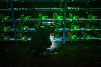 epaselect epa06062675 (04/26) Bitcoin miner Huang inspects a malfunctioning mining machine during his night shift at the Bitcoin mine in Sichuan Province, China, 26 September 2016. Miners can check a machine's condition and operations using phones and personal computers. For most issues, they can simply restart a machine. 'If it's a complicated problem, we just ship it to the factory and let them fix it,' Huang said.
China is one the main exchange market of bitcoins although the digital currency exists in a legal limbo and prone to speculation. The country hosts some of the biggest 'mining pools' in the world, clusters of supercomputers which task is minting new bitcoins and maintaining the system, sometimes installed in shady places close to power plants. Sichuan has become known as 'the capital of bitcoin mining' as entrepreneurial Chinese set up 'mines' there due to its abundance of hydropower, perfect for the high electricity needs of the large number of computers required for Bitcoin mining. Bitcoin mines are buildings with warehouse-like structures equipped with massive numbers of microprocessors with which 'miners' solve complex math problems and are rewarded in the digital currency.
The industry exists in a legal gray zone in China, and the miners in this story, concerned about attention from the government, asked not to have their full names or the names of the villages where their mines are located mentioned in this story.  EPA/LIU XINGZHE/CHINAFILE ATTENTION: For the full PHOTO ESSAY text please see Advisory Notice epa06062671