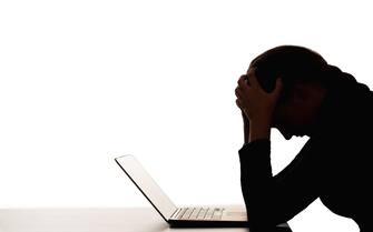 female silhouette overwork burnout woman laptop